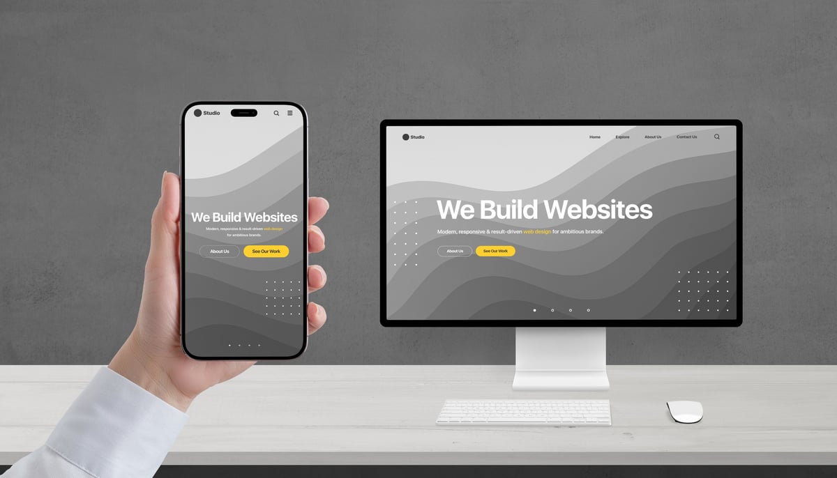 Responsive web design portfolio displayed on desktop monitor and smartphone — 'We Build Websites' creative studio concept